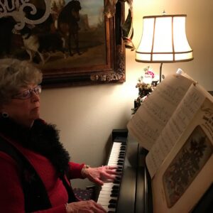Donna tickling the ivories with Christmas music.
