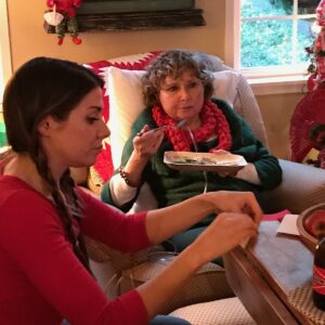 Kara teaching Carol how to make origami balloons.