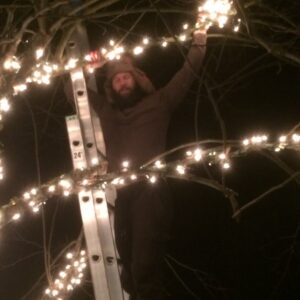 Tanner wrapping backyard trees.